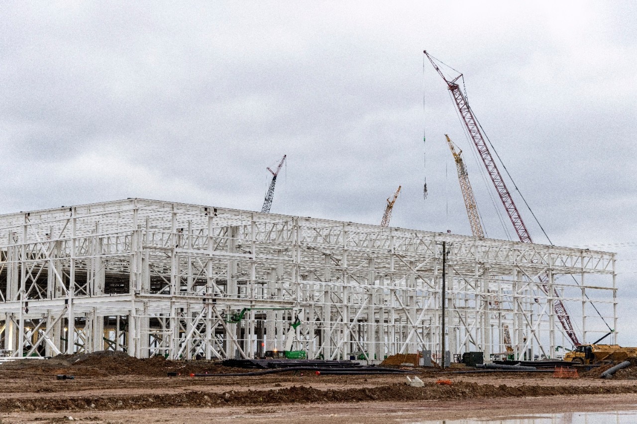 View of Blue Oval City facility udner construction with cranes in the background