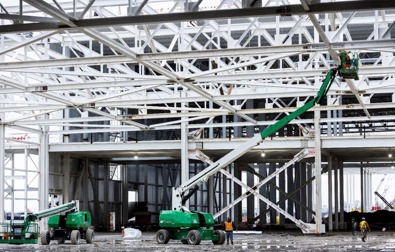 Close up view of Blue Oval City facility under construction with equipment in the foreground