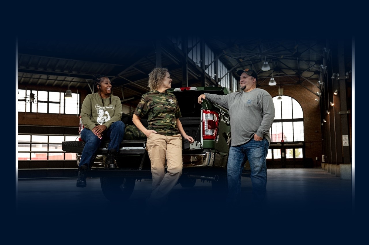 Three Ford Veterans having a conversation by a Ford F-150